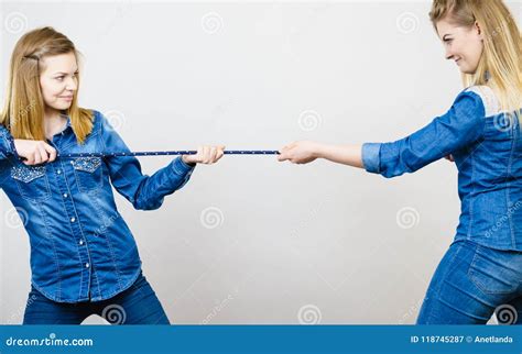 2 girls pulling a rope|Two Persons Pulling Rope royalty